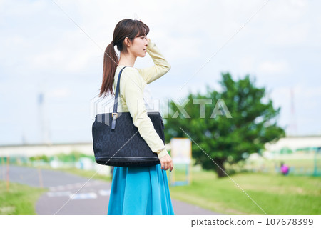 Young woman blue sky park 107678399