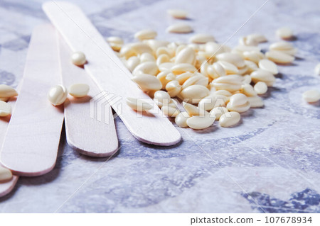 Wax for hair removal. Hair removal with wax. 107678934