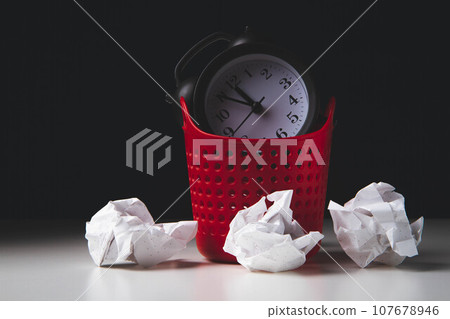 Early rise. Alarm clock in the trash. Woke up. Clock in the trash can. 107678946