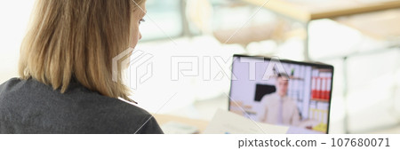 Manager talks to partner on video call via modern laptop Manager talks to partner on video call via modern laptop 107680071