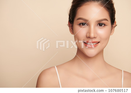 Beautiful young asian woman with clean fresh skin on beige background, Face care, Facial treatment, Cosmetology, beauty and spa, Asian women portrait. 107680517