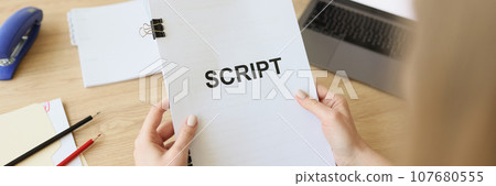 Hands of woman holding script papers for filming TV show Hands of woman holding script papers for filming TV show 107680555