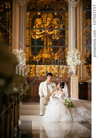 Bride and groom looking at each other in the church at night Bride and groom looking at each other in the church at night 107681557
