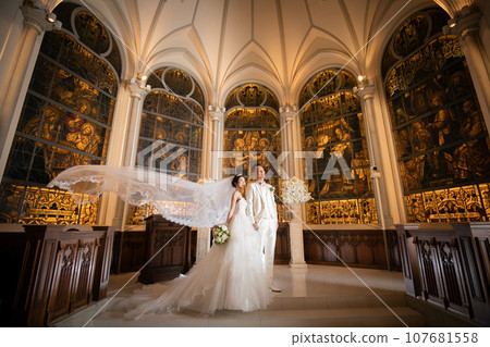 The bride's veil flutters in the church at night The bride's veil flutters in the church at night 107681558