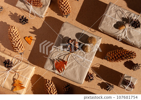Zero waste Christmas knolling concept flat lay hard shadows. Hand craft eco gift natural New Year decorations top view. 107681754