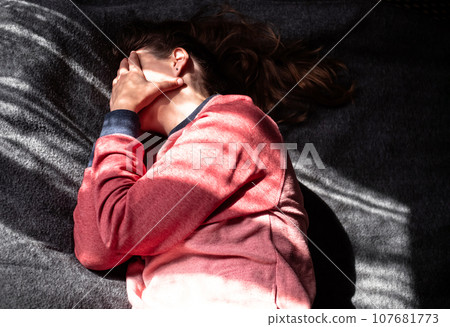 Stressed tired millennial woman on bed eyes closed suffers from headache Mental health Psychology Traumatic experience Stressed tired millennial woman on bed eyes closed suffers from headache Mental health Psychology Traumatic experience 107681773