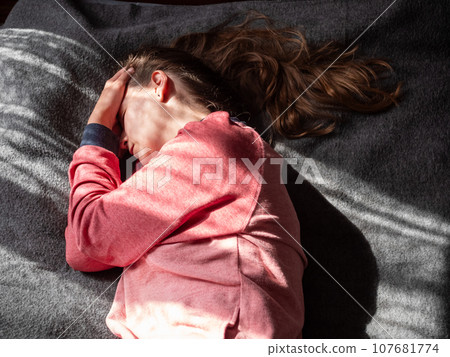 Stressed tired millennial woman on bed eyes closed suffers from headache Mental health Psychology Traumatic experience Stressed tired millennial woman on bed eyes closed suffers from headache Mental health Psychology Traumatic experience 107681774