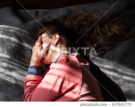 Stressed tired millennial woman on bed eyes closed suffers from headache Mental health Psychology Traumatic experience Stressed tired millennial woman on bed eyes closed suffers from headache Mental health Psychology Traumatic experience 107681775