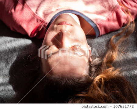 Stressed tired millennial woman on bed eyes closed suffers from headache Mental health Psychology Traumatic experience Stressed tired millennial woman on bed eyes closed suffers from headache Mental health Psychology Traumatic experience 107681778