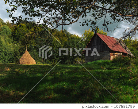 Old authentic wooden house hayloft Carpathian mountains Ukraine Europe Transcarpathia region. Eco tourism Cottagecore Old authentic wooden house hayloft Carpathian mountains Ukraine Europe Transcarpathia region. Eco tourism Cottagecore 107681799
