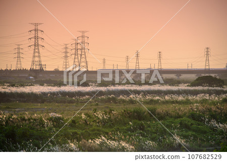 At dusk and sunset, a high-speed train passes over the bridge. At dusk and sunset, a high-speed train passes over the bridge. 107682529