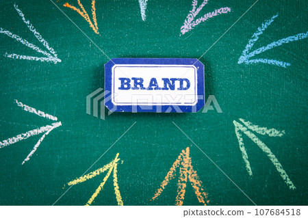 BRAND Concept. Sticker on a green chalkboard background BRAND Concept. Sticker on a green chalkboard background 107684518