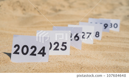 Paper cards with numbers of years from 2024 to 2030 in a row. New year start concept. Resolution time is flying plan goal motivation 107684648