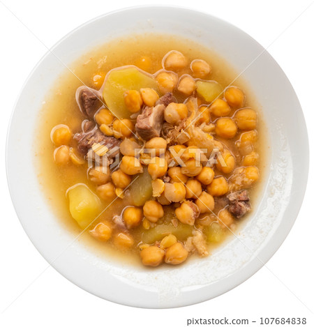 Chickpea hearty soup, seasonal vegetables and beef meat in deep dinner plate Chickpea hearty soup, seasonal vegetables and beef meat in deep dinner plate 107684838