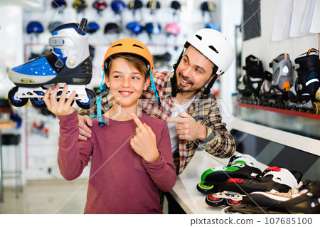 Father and son enjoying purchased roller-skates 107685100
