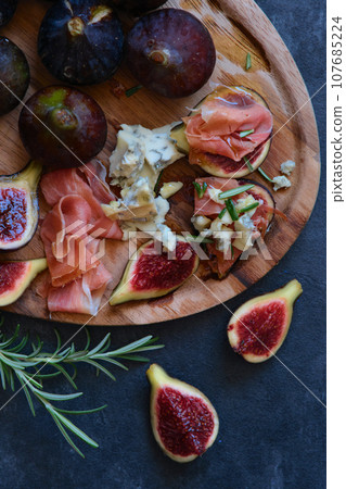 figs cheese with mold and jamon figs cheese with mold and jamon 107685224