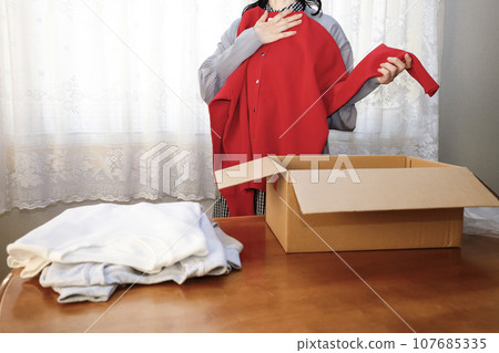 Red is a must-have this year. A woman who buys clothes online and tries them on immediately. 107685335