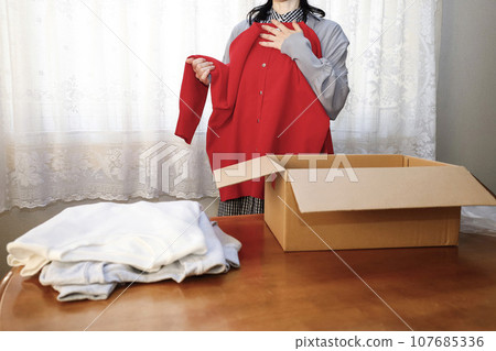 Red is a must-have this year. A woman who buys clothes online and tries them on immediately. 107685336
