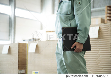 Young worker working in a warehouse 107685883