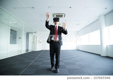 Young businessman watching VR in the office Young businessman watching VR in the office 107685946