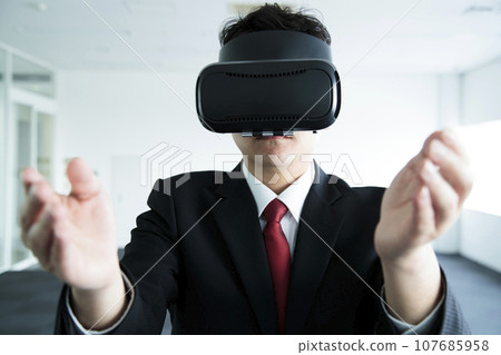 Young businessman watching VR in the office 107685958