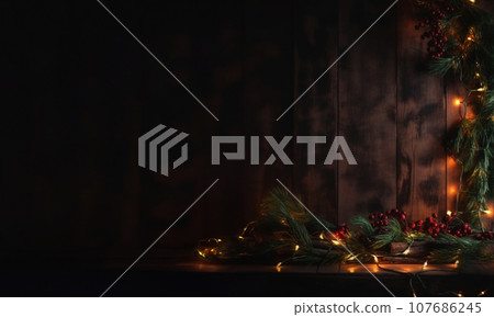 Creative Christmas greeting card. Green fir branches with Christmas lights and red berries on brown wooden boards background. Xmas decorations. Copy space. Horizontal format. Generated AI. 107686245