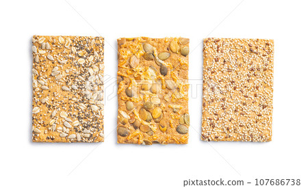 Knackebrot with sesame and pumpkin seeds. Wholegrain crispbread isolated on white background. Knackebrot with sesame and pumpkin seeds. Wholegrain crispbread isolated on white background. 107686738