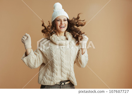 happy stylish woman isolated on beige background jumping happy stylish woman isolated on beige background jumping 107687727