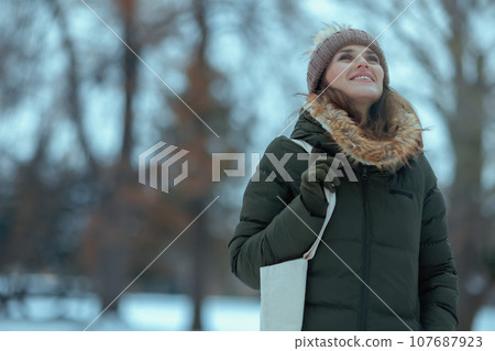 happy modern woman outdoors in city park in winter happy modern woman outdoors in city park in winter 107687923