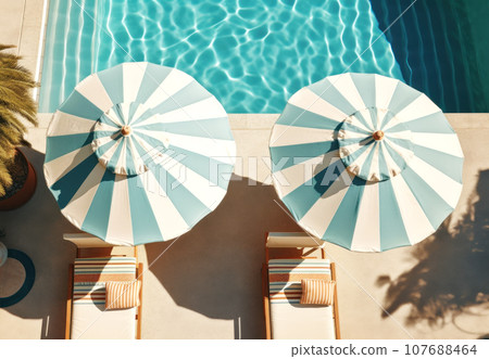 Striped blue and white umbrellas, sun beds, pots with plants and a swimming pool 107688464