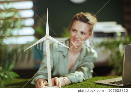 Happy business woman in green blouse in green office Happy business woman in green blouse in green office 107688810