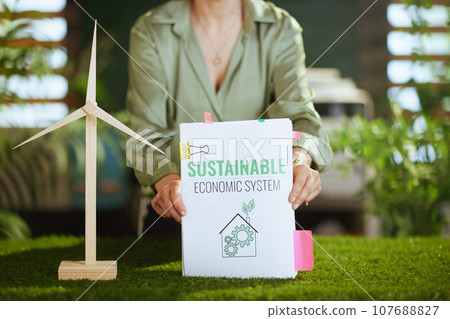 Business owner woman in green office showing eco business plan 107688827