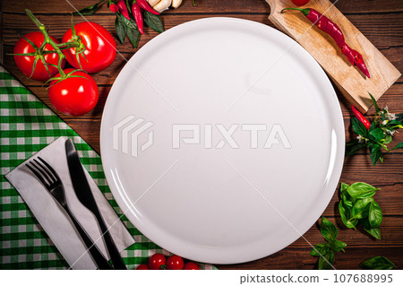 Background for Pizza with tomatoes, mozzarella cheese, black olives and basil. Mock up for Delicious italian pizza on wooden table. Table top view 107688995