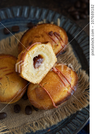 Pasticciotto leccese pastries on a dark blue plate on dark table close up 107689182
