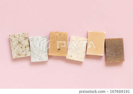 Beige and brown handmade soap bars on light pink top view. Natural herbal product for SPA Beige and brown handmade soap bars on light pink top view. Natural herbal product for SPA 107689191