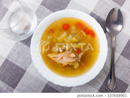 Fish soup with salmon bones and vegetables Fish soup with salmon bones and vegetables 107689901