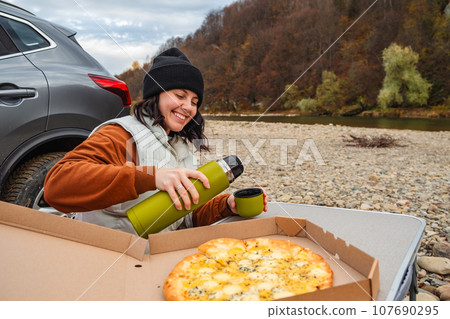 happy woman drinking warm tea road trip concept happy woman drinking warm tea road trip concept 107690295
