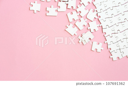 Puzzle pieces on pink background 107691362