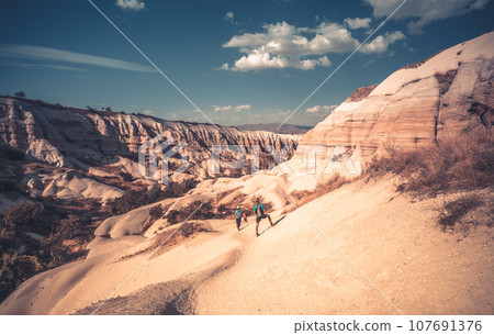 Tourists trekking to canyon in Cappadocia 107691376