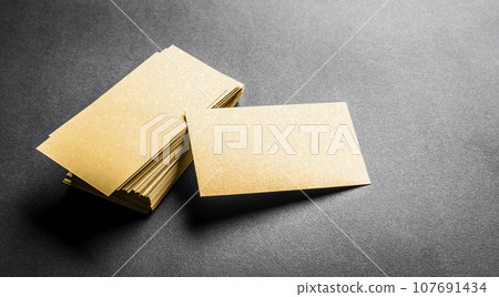 Blank golden business card on grey background 107691434