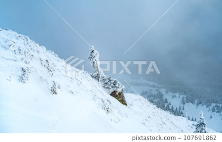 Mountain landscape with snowfall and clouds 107691862