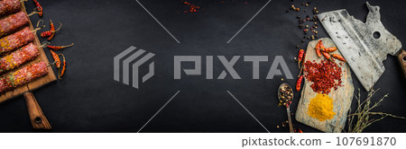 Raw kebab with pepper and spices 107691870