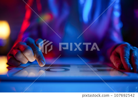 Closeup on woman using tablet PC Closeup on woman using tablet PC 107692542