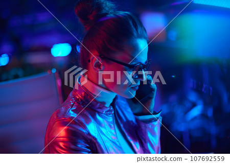 elegant business woman in glasses talking on smartphone elegant business woman in glasses talking on smartphone 107692559