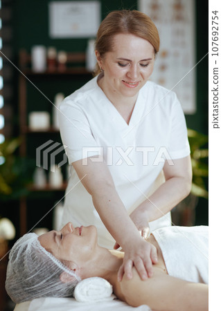 massage therapist in spa salon massaging clients shoulder massage therapist in spa salon massaging clients shoulder 107692754