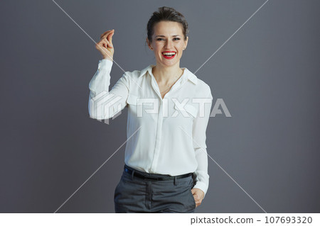 happy elegant woman worker fingers snapping isolated on gray happy elegant woman worker fingers snapping isolated on gray 107693320