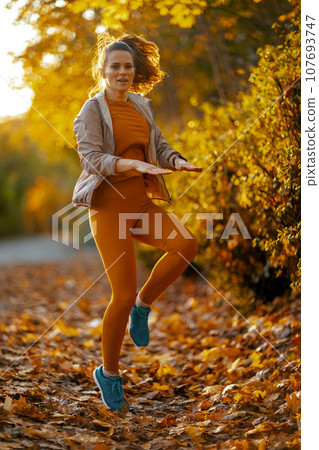 modern female in fitness clothes in park workout modern female in fitness clothes in park workout 107693747