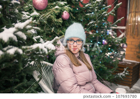 Pretty woman with fir tree Pretty woman with fir tree 107693780