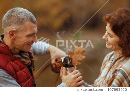 smiling stylish family in park with autumn leaf smiling stylish family in park with autumn leaf 107693920