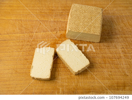Tofu Cheese Isolated, Smoked Vegan Cheese Slice, Sliced Soya Bean Curd, Soy Protein or TSP 107694249